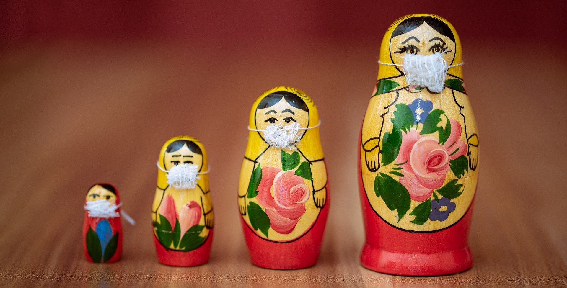 Russian nesting dolls wearing masks