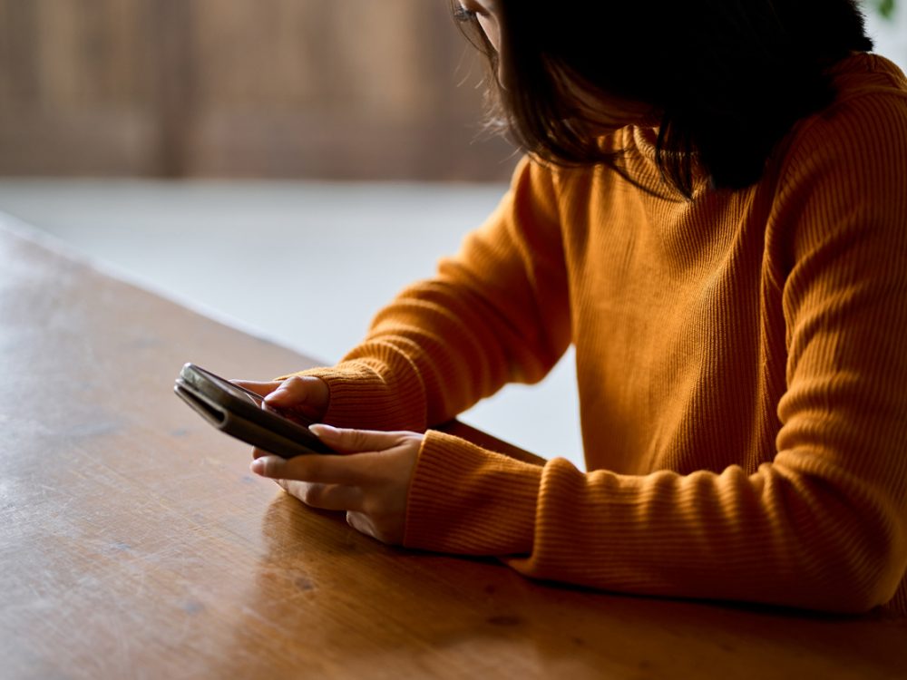 A woman looking at her smartphone.