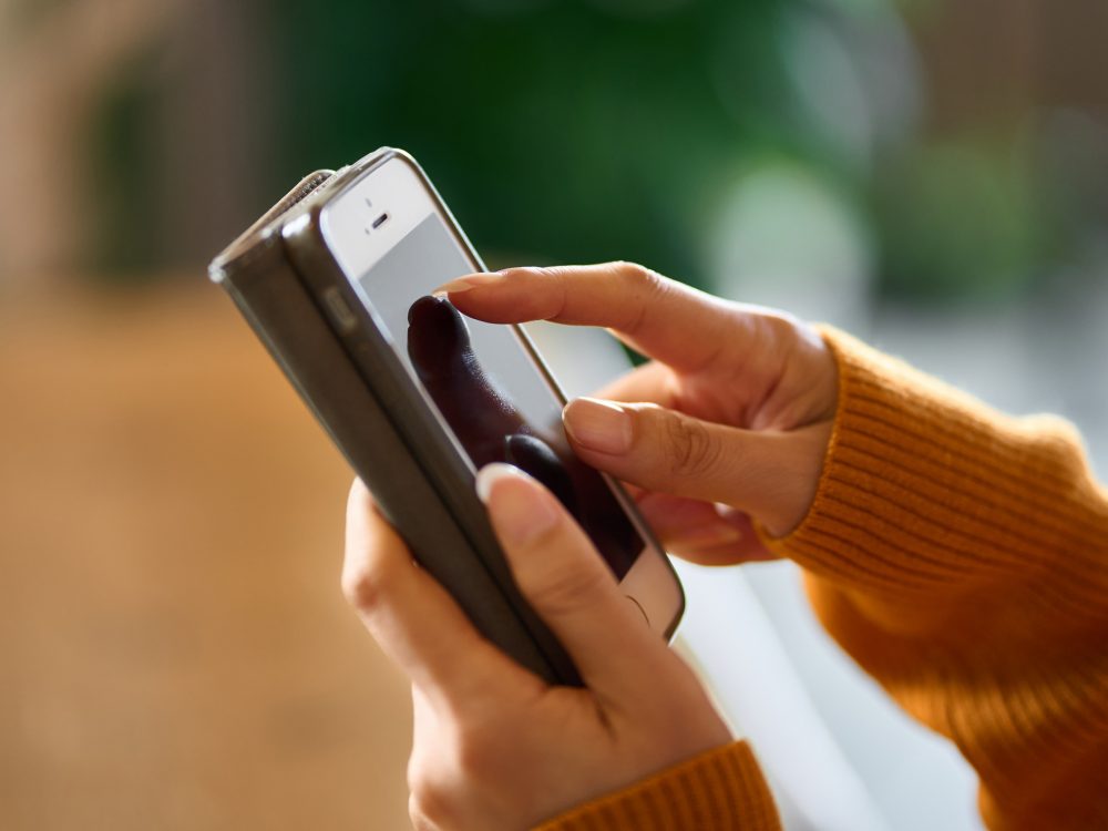Two female hands holding a smartphone
