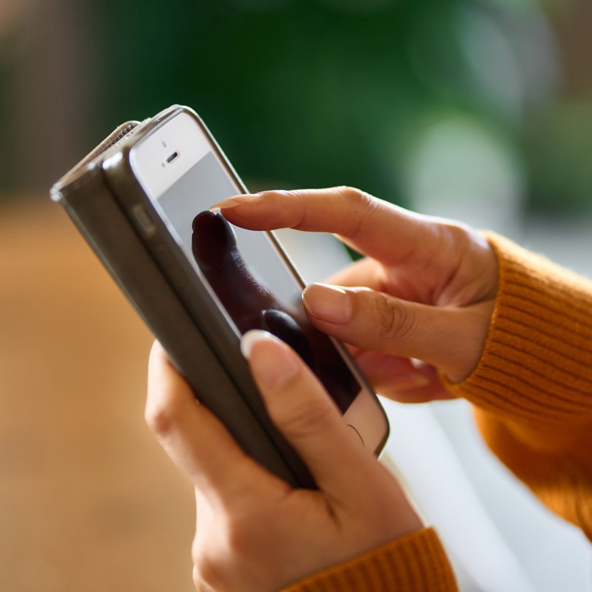 Two female hands holding a smartphone